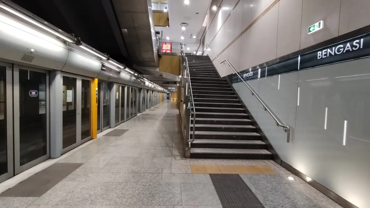 La banchina della fermata Bengasi della metro 1, con le porte di vetro e le scale
